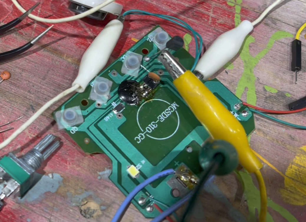 A small circuit board from an obnoxious toy truck that makes sounds.